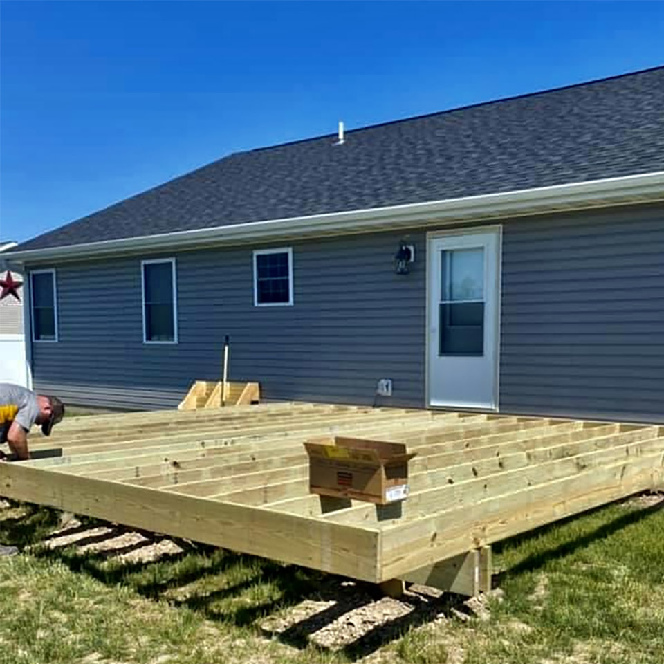 a deck being constructed on the back of a house