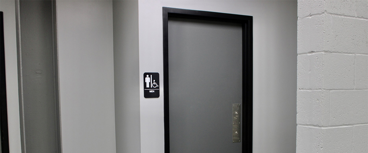 women bathroom sign near a bathroom door